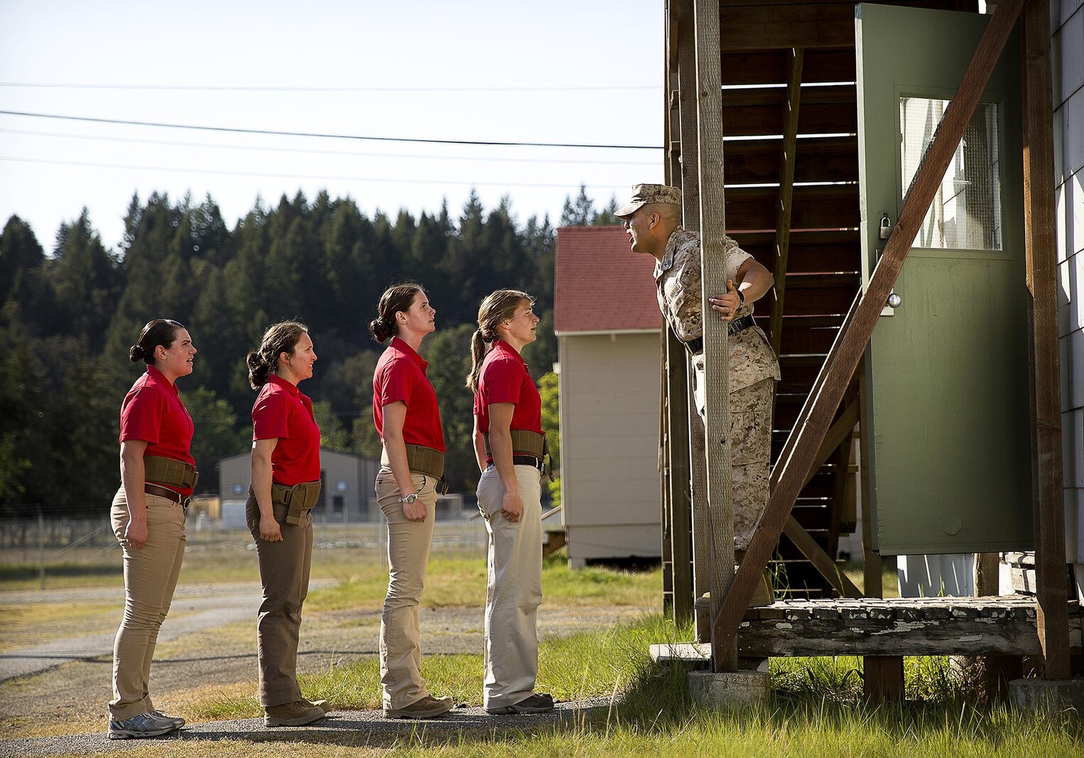 JOINT BASE LEWIS-MCCHORD, Wa. -- Gunnery Sgt. Agustin Juradosegovia, a sergeant instructor from Oxnard, California, instructs Marine Corps officer candidates before they enter barracks during Officer Candidates School preparation at Joint Base Lewis-McChord, Washington, May 8, 2015. During the three-day event, Seattle-based sergeant instructors and officer recruiters worked together to physically and mentally prepare candidates for the rigors of OCS, which the candidates will later attend aboard Marine Corps Base Quantico, Virginia. The candidates pictured are (left to right) Nicole Compton from Seabeck, Washington; Anna Sigel from Lancaster, Pennsylvania; Tess Carlin from Auburn, Washington; and Sydney Williams from Bremerton, Washington. (U.S. Marine Corps photo by Sgt. Reece Lodder)