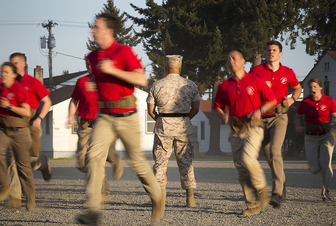 JOINT BASE LEWIS-MCCHORD, Wa. -- Gunnery Sgt. Agustin Juradosegovia, a sergeant instructor from Oxnard, California, observes Marine Corps officer candidates as they prepare to create a formation during Officer Candidates School preparation at Joint Base Lewis-McChord, Washington, May 8, 2015. During the three-day event, Seattle-based sergeant instructors and officer recruiters worked together to physically and mentally prepare candidates for the rigors of OCS, which the candidates will later attend aboard Marine Corps Base Quantico, Virginia. (U.S. Marine Corps photo by Sgt. Reece Lodder)