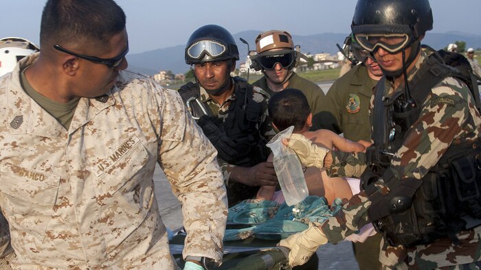 KATHMANDU, Nepal (May 12, 2015) - U.S. service members from Joint Task Force 505 and Nepalese soldiers unload an injured child to a medical triage area at Tribhuvan International Airport after a 7.3 magnitude earthquake struck the country. Joint Task Force 505 along with other multinational forces and humanitarian relief organizations are currently in the Nepal providing aid after a 7.8 magnitude earthquake struck the country, April 25. At Nepal's request the U.S. government ordered JTF 505 to provide unique capabilities to assist Nepal.