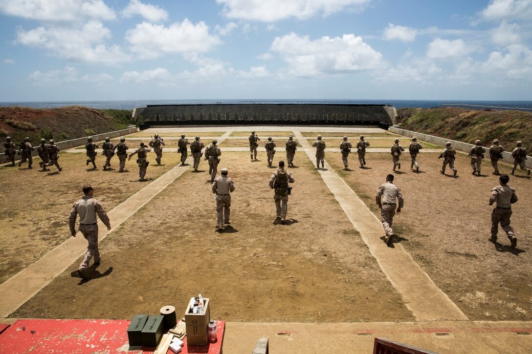 U.S. Marines with the 15th Marine Expeditionary Unit’s Maritime Raid Force run towards their targets while training to enhance their marksmanship skills aboard Marine Corps Base Hawaii, May 10, 2015. The MRF provides the MEU a flexible, lethal force capable of a wide variety of missions while deployed.  (U.S. Marine Corps photo by Cpl. Anna Albrecht/Released)