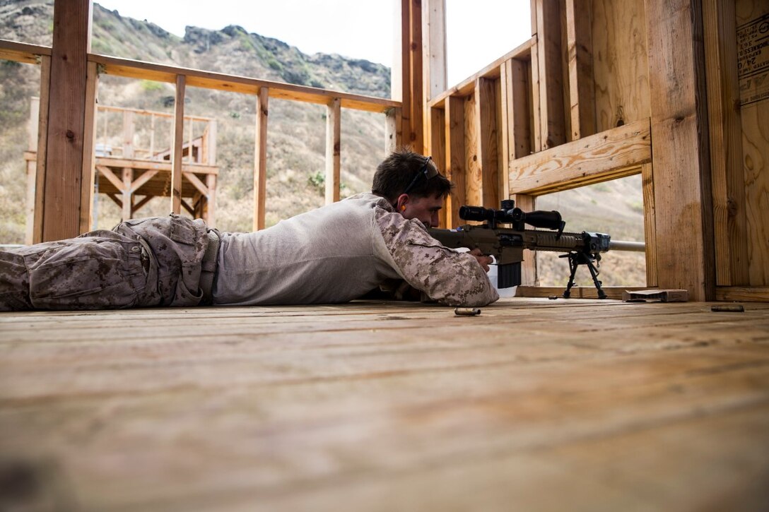 U.S. Marine Cpl. Dillon Thomas aims at his target on an unknown distance range aboard Marine Corps Base Hawaii, May 10, 2015. Thomas is with the 15th Marine Expeditionary Unit’s Maritime Raid Force. The MRF is practicing marksmanship skills before joining the 15th MEU on their current deployment in the Pacific. These Marines frequently sustain their marksmanship skills to ensure they are ready for anything they may face on deployment. (U.S. Marine Corps photo by Cpl. Anna Albrecht/ Released)