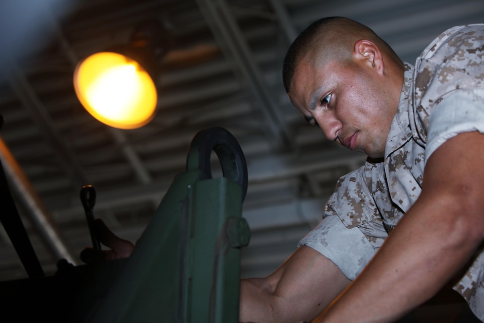 Corporal Erix A. Quinteros works on the engine of a Medium Tactical Vehicle Replacement Extended Cargo Truck at Marine Corps Air Station Cherry Point, North Carolina May 11, 2015. Quinteros received the Maintenance Technician of the Year Award for excelling as an automotive maintenance technician since joining with Marine Wing Communications Squadrons 28 last year. 