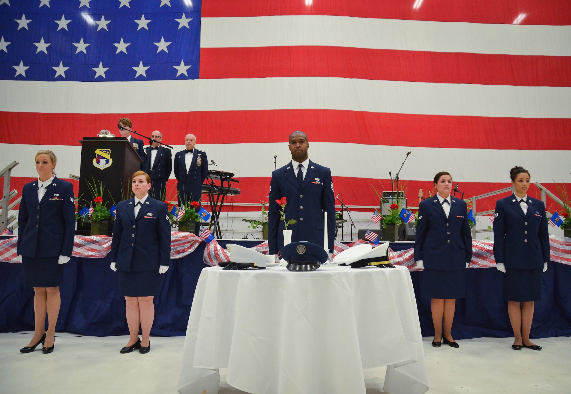 The Rising 6 Enlisted Council of the128th Air Refueling Wing performed the POW Missing Man Ceremony at the 35th annual Civic Dinner Dance in the aircraft hangar here May 14, 2015.  The Civic Dinner Dance is an event coordinated by the Milwaukee Armed Forces Committee for Wisconsin military members, elected state and local officials, and citizens of the local Milwaukee area to celebrate community relations during Armed Forces Week.  (U.S. Air National Guard photo by Tech. Sgt. Jenna Lenski/Released)