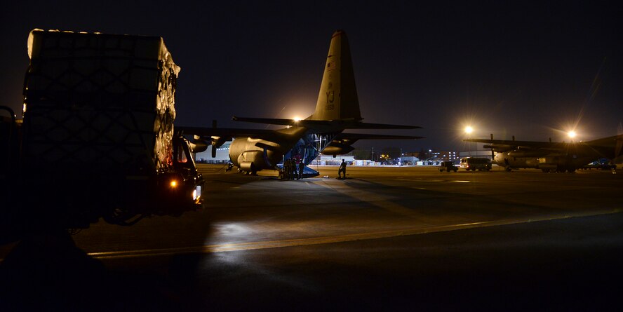 The C-130 Hercules aircrew prepares to load cargo onto the aircraft May 14, 2015, at Yokota Air Base, Japan. The C-130H was originally designed as a troop, medivac and cargo transport aircraft. (U.S. Air Force photo by Senior Airman David Owsianka/Released)