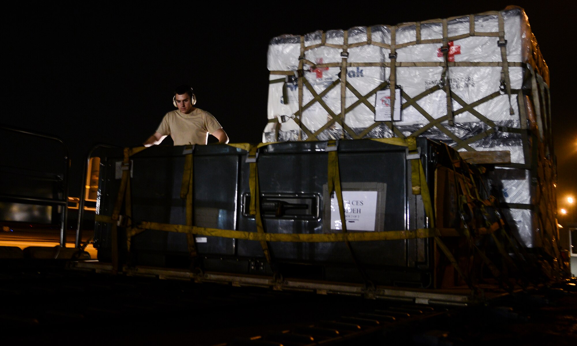 Airman 1st Class Josh Utley, 730th Air Mobility Squadron airframe journeyman, tightens cargo on a 60K-loader May 14, 2015, at Yokota Air Base, Japan. The loader can transport up to six pallets of cargo at a time. (U.S. Air Force photo by Senior Airman David Owsianka/Released)