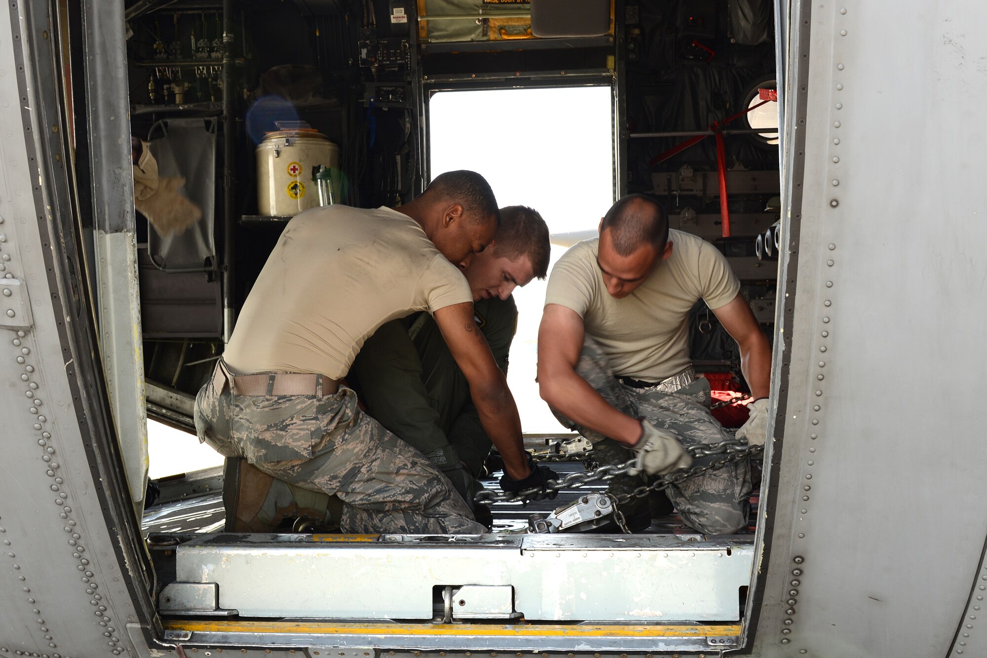 Augmentees with the 374th Logistics Readiness Squadron and Airmen from the 36th Airlift Squadron work together to secure a K-loader inside a C-130 Hercules May 14, 2015, at Yokota Air Base, Japan. The Airmen loaded the equipment as part of a readiness inspection. (U.S. Air Force photo by Senior Airman Desiree Economides/Released)