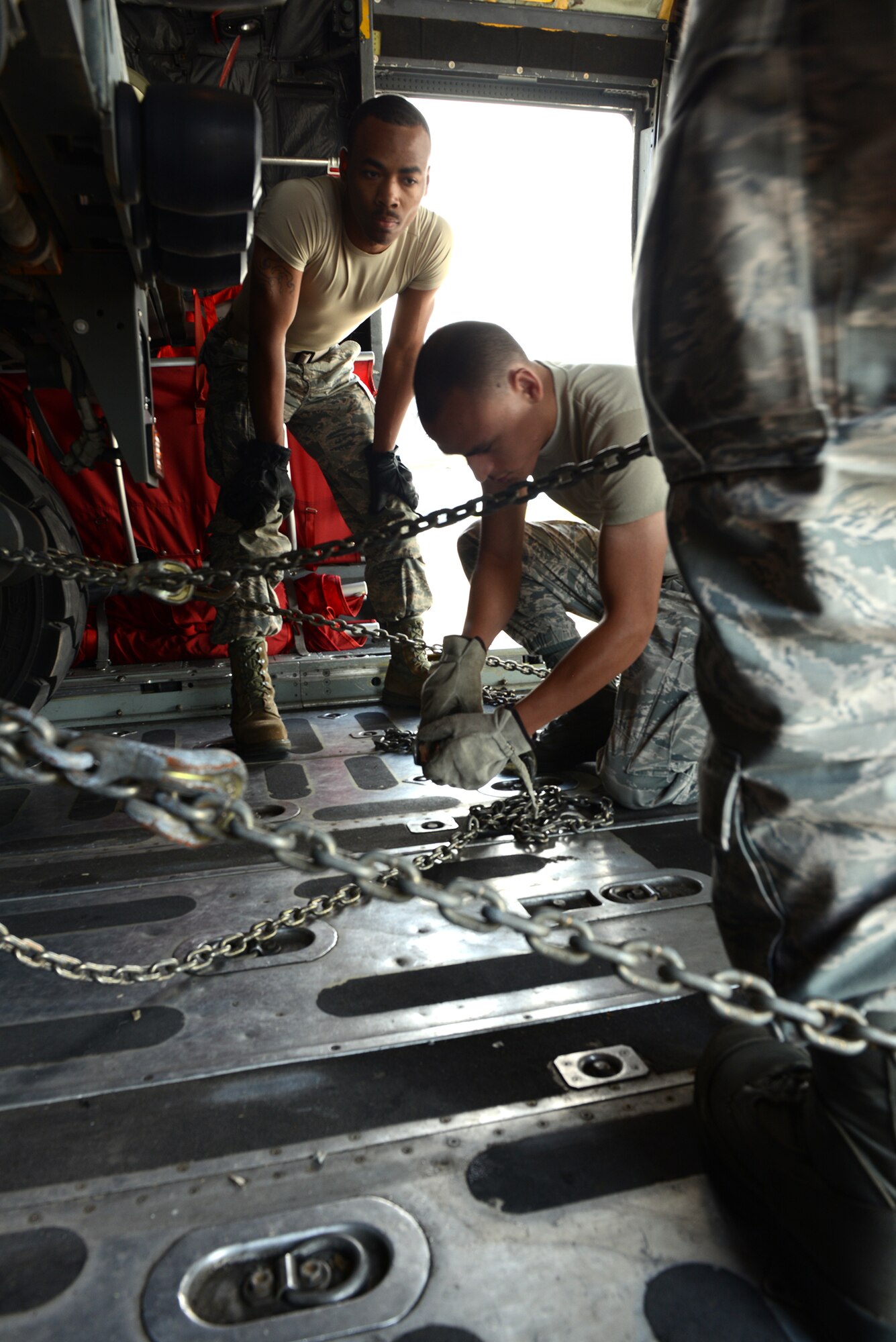 Airmen from the 374th Airlift Wing secure a K-loader inside a C-130 Hercules May 14, 2015, at Yokota Air Base, Japan.  As part of a readiness inspection, Airmen tested their ability to receive and deploy forces and equipment. (U.S. Air Force photo by Senior Airman Desiree Economides/Released)