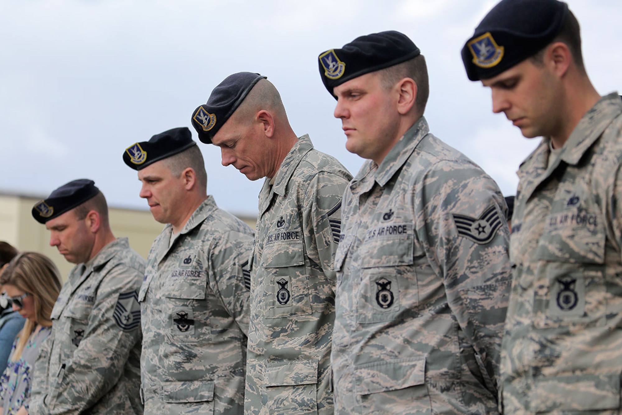 Airmen assigned to the 673rd Security Forces Squadron bow their heads during a memorial ceremony honoring Staff Sgt. Brian McElroy and Tech. Sgt. Jason L. Norton on Joint Base Elmendorf-Richardson Monday. A memorial plaque was unveiled for McElroy and Norton who were both killed in 2006 while deployed in support of Operation Iraqi Freedom. (U.S. Air Force photo/Alejandro Pena)