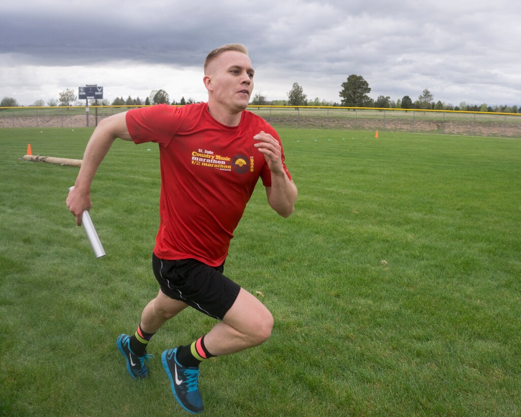 Capt. Jonathan Dial, 90th Missile Wing Judge Advocate, sprints the 50-yard relay section of the team torture event May 13, 2015, on F.E. Warren Air Force Base. The event also included a 50-yard tire flip, 50-yard log carry, and a 50-yard body drag. (U.S. Air Force Photo by Lan Kim)
