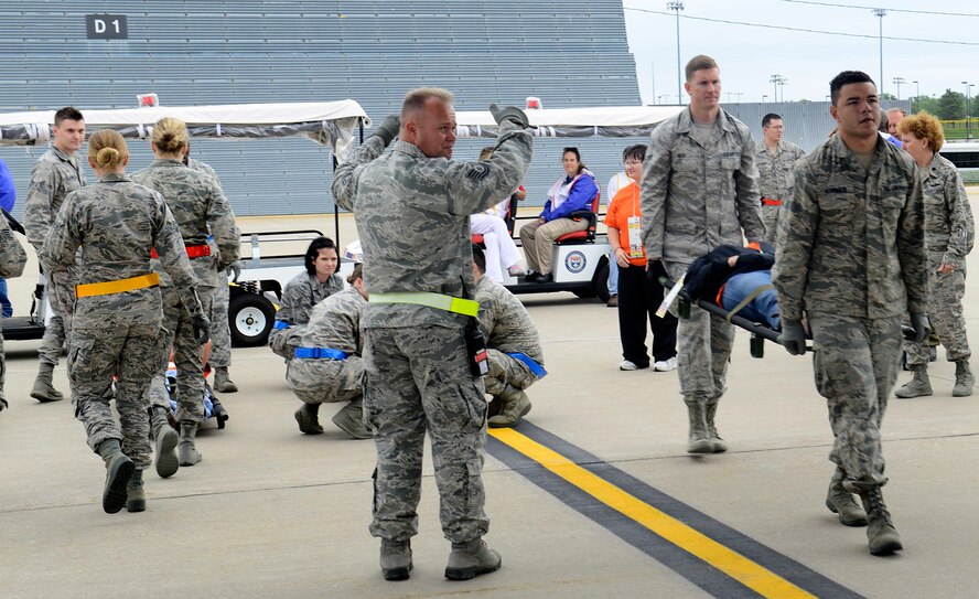 Members of the 22nd Medical Group transport patients onto a C-130 Hercules from the Minnesota Air National Guard, May, 13, 2015, at McConnell Air Force Base, Kan. The 22nd MDG participated in a training exercise, alongside the Robert J. Dole Veterans Affairs Medical Center and representatives from local hospitals. The training prepared the agencies to respond in the event a disaster struck an area and patients had to be transported here for care. (U.S. Air Force photo by Senior Airman Trevor Rhynes)