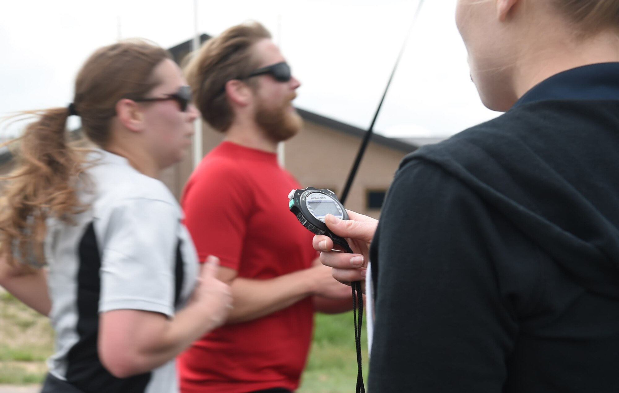 A Team Buckley member records runner’s times as they run through the finish line during the Dash to Distance 8k May 13, 2015, at the outdoor track on Buckley Air Force Base, Colo. The Dash to Distance series started with an 8k and will gradually increase to a 12k, 10 mile and half marathon run. Prizes were awarded to top male and female finishers, along with Commander Cup points. (U.S. Air Force photo by Airman 1st Class Samantha Meadors/Released)