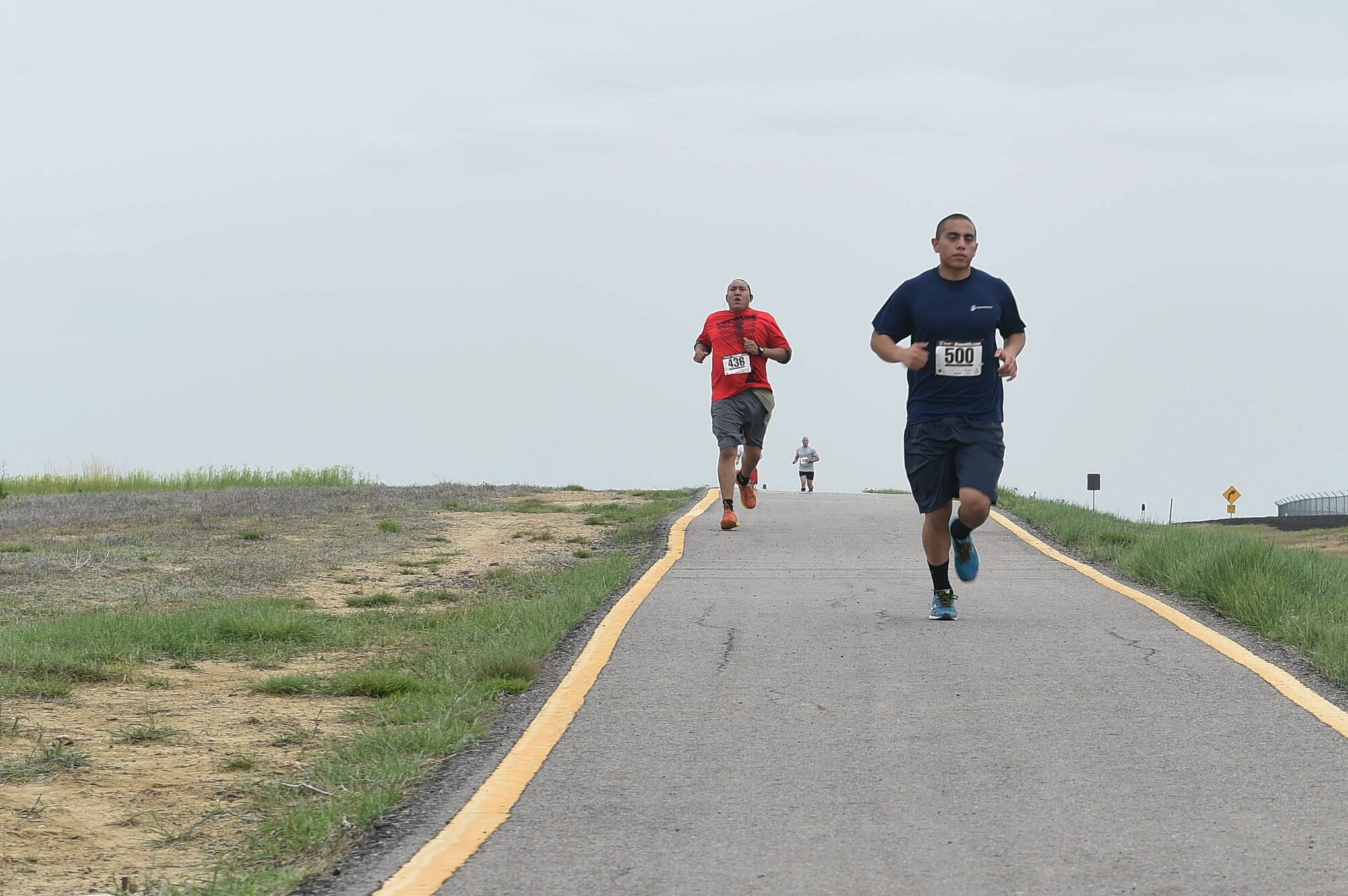 Team Buckley racers run in the Dash to Distance 8k May 13, 2015, at the outdoor track on Buckley Air Force Base, Colo. The Dash to Distance series started with an 8k and will gradually increase to a 12k, 10 mile and half marathon run. Prizes were awarded to top male and female finishers, along with Commander Cup points. (U.S. Air Force photo by Airman 1st Class Samantha Meadors/Released)