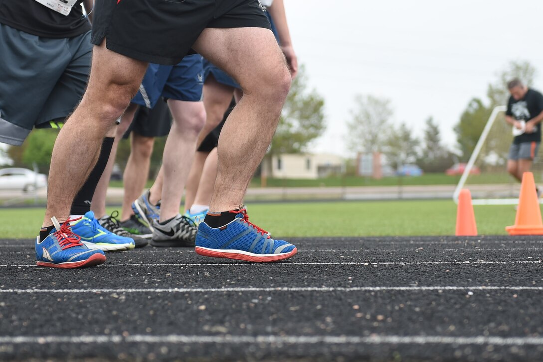 Runners from all over Team Buckley line up to race in the Dash to Distance 8k May 13, 2015, at the outdoor track on Buckley Air Force Base, Colo. The Dash to Distance series started with an 8k and will gradually increase to a 12k, 10 mile and half marathon run. Prizes were awarded to top male and female finishers, along with Commander Cup points. (U.S. Air Force photo by Airman 1st Class Samantha Meadors/Released)
