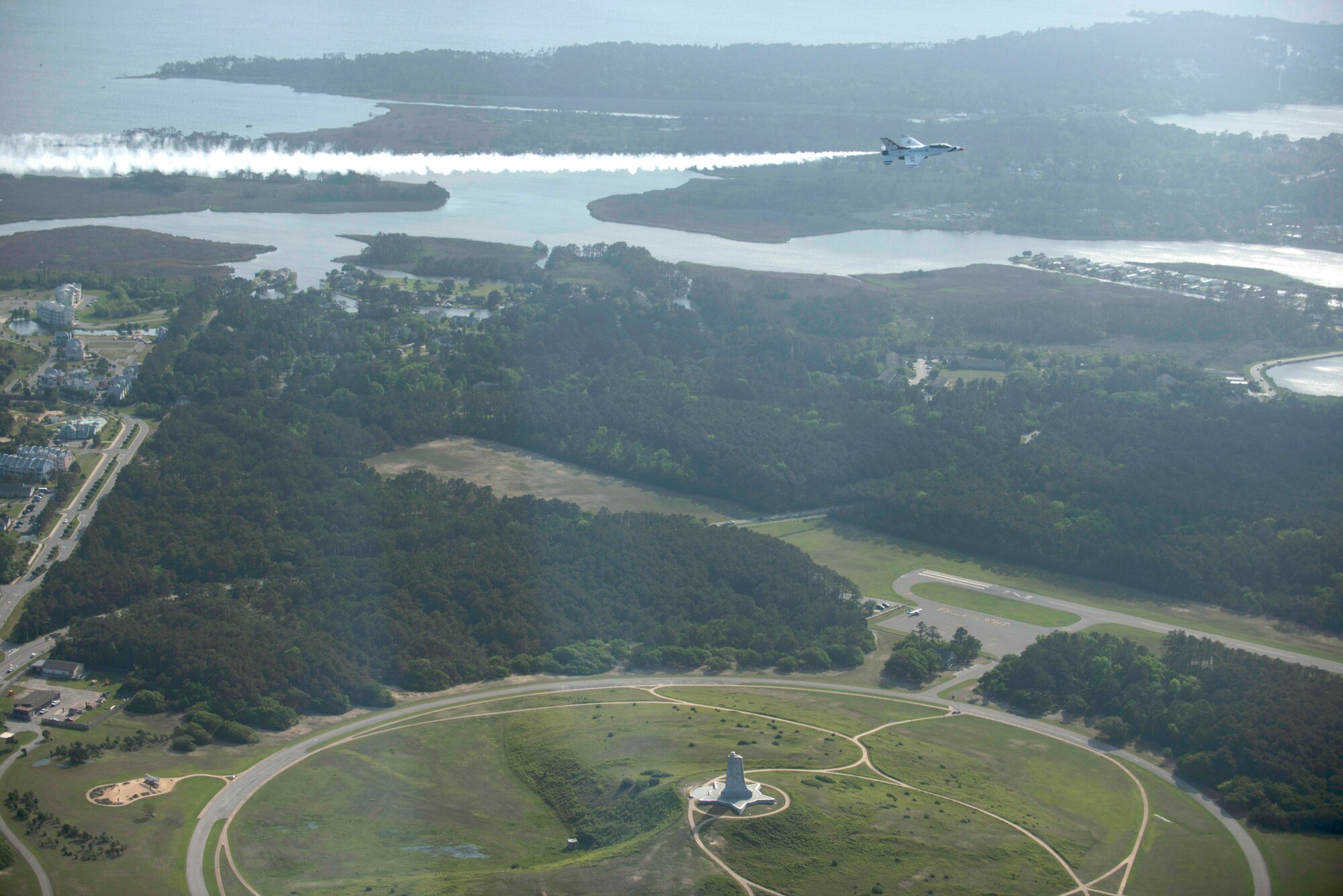 An F-16 Fighting Falcon with the U.S. Air Force Thunderbirds aerial demonstration team flies over the Wright Brothers National Memorial, May 12, 2015, in Kitty Hawk, North Carolina.  The memorial marks  the sight of the first successful, sustained flight of Orville and Wilbur Wright, known as the fathers of modern aviation. (U.S. Air Force photo/Master Sgt. Jocelyn L. Rich-Pendracki)