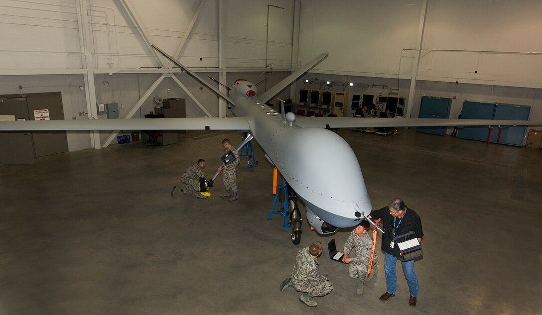 Andrew Dickman, 365th Training Squadron fighter avionics instructor, train Airmen assigned to the Remotely Piloted Aircraft Avionics Apprentice Course at Sheppard Air Force Base, Texas May 13, 2015. Students learn the importance of the individual system components and ensure all safety checks are performed to the highest of standards. The course is intended to train Airmen how to perform safe maintenance on the Ground Control Station and MQ-9 Reaper. (U.S. Air Force photo by Danny Webb/Released)