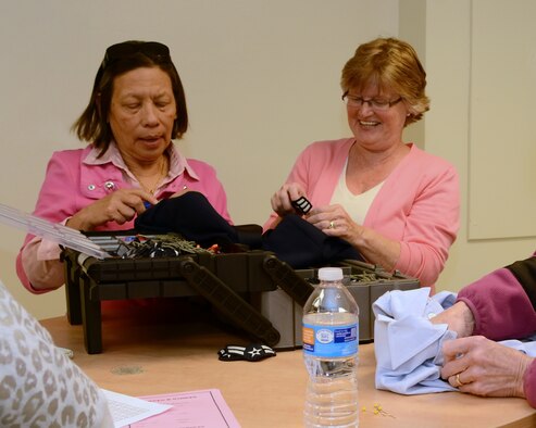 Volunteers add stripes to uniforms during the Gravity's monthly Supper and Stripes event. (Photo by Jamie Burnett)
