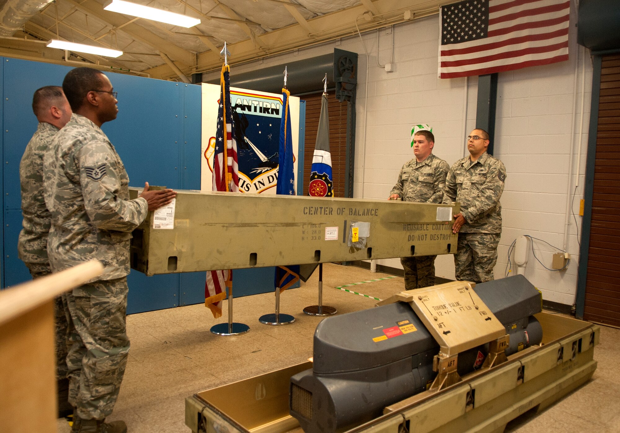 A detail from the 4th Component Maintenance Squadron Sensors Centralized Repair Facility closes a symbolic container during the CRF’s deactivation ceremony, May 8, 2015, at Seymour Johnson Air Force Base, North Carolina. The CRF has supported several operations, including ENDURING FREEDOM and NOBLE EAGLE, through its targeting pod repairs. (U.S. Air Force photo/Senior Airman Ashley J. Thum)