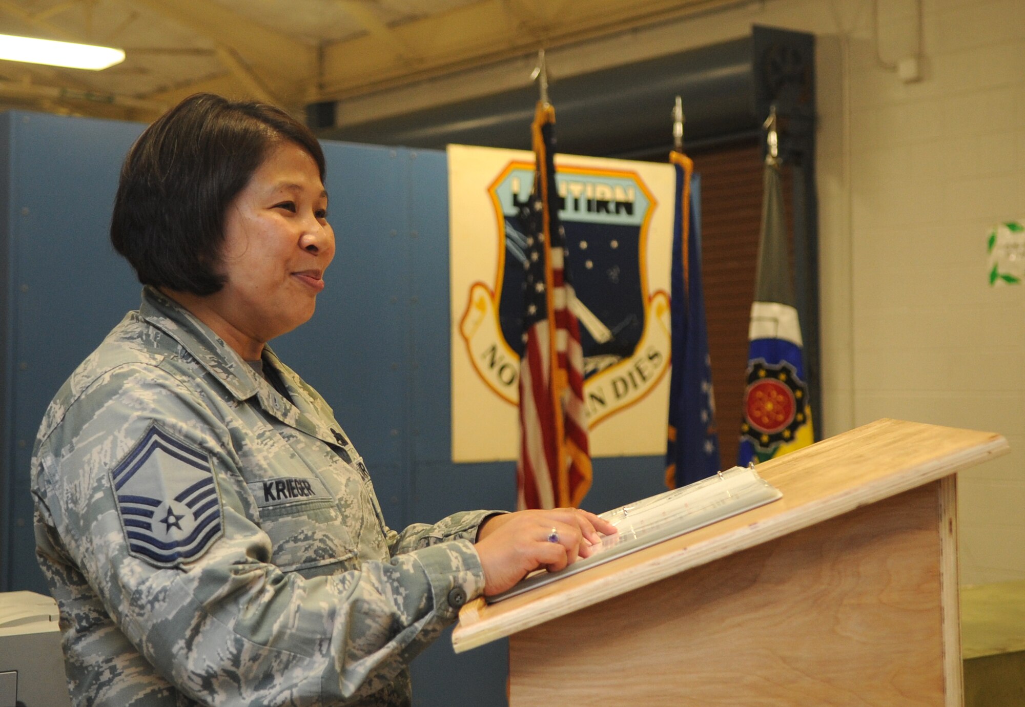 Senior Master Sgt. Josephine Krieger, 4th Component Maintenance Squadron avionics flight chief, reads the deactivation order for the squadron’s sensors centralized repair facility, May 8, 2015, at Seymour Johnson Air Force Base, North Carolina. The CRF upheld a more than  86 percent mission-capable rate for its serviced targeting pods throughout its history. (U.S. Air Force photo/Senior Airman Ashley J. Thum)
