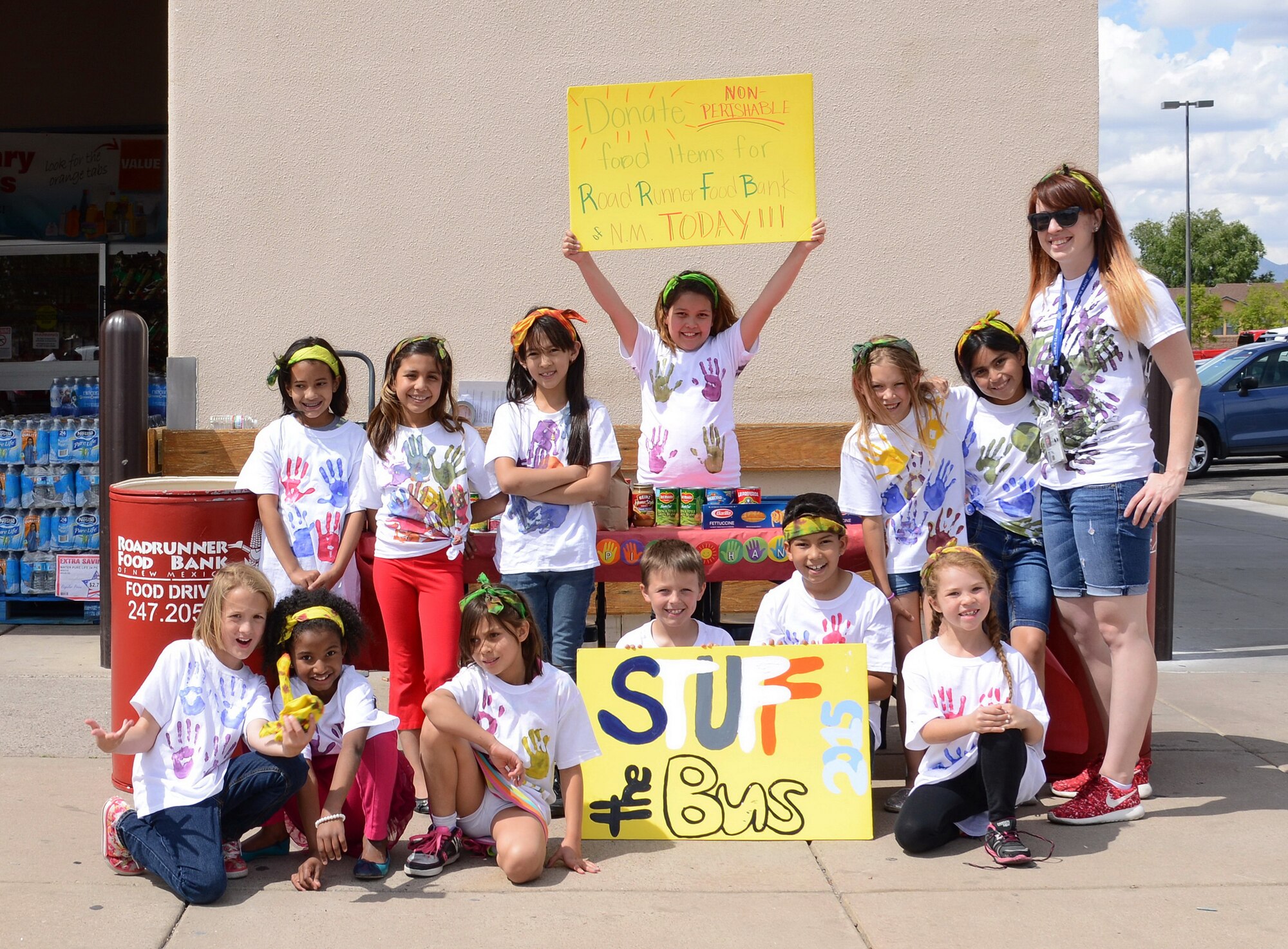 Young volunteers from the Youth Center’s Helping Hands Club pose for a picture while gathering donations for Roadrunner Food Bank at the Commissary on May 6. (Photo by Jamie Burnett)