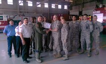 Staff Sgt. Michael Haynes, center, 47th Civil Engineering Squadron civil engineering flight NCO in charge of logistics, poses with Col. Brian Hastings, foreground left, 47th Flying Training Wing commander, Chief Master Sgt. Teresa Clapper, foreground right, 47th FTW command chief, and members of the 47th CES after accepting the XLer of the Week award here May 6, 2015. The XLer is a weekly award chosen by wing leadership and is presented to those who consistently make outstanding contributions to their unit and Laughlin. (Courtesy photo)