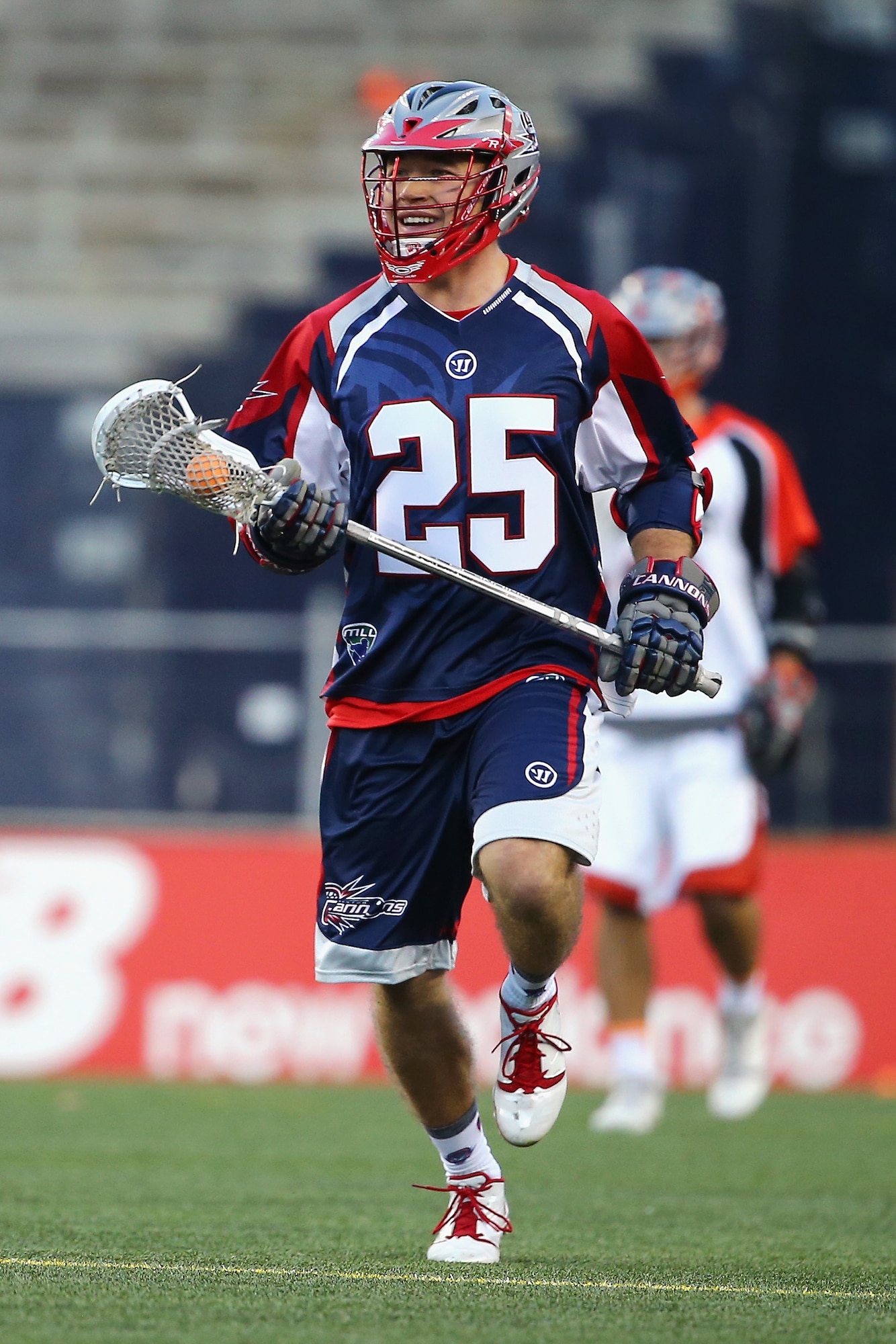 Erik Smith (25) cradles the ball during a break in the action against the Denver Outlaws game earlier this season at Gillette Stadium in Foxboro, Mass. The Boston Cannons, who drafted Smith with the 37th overall pick in last year's MLL draft, is a second lieutenant assigned to the C3I and Networks Directorate at Hanscom Air Force Base. (Courtesy photo)