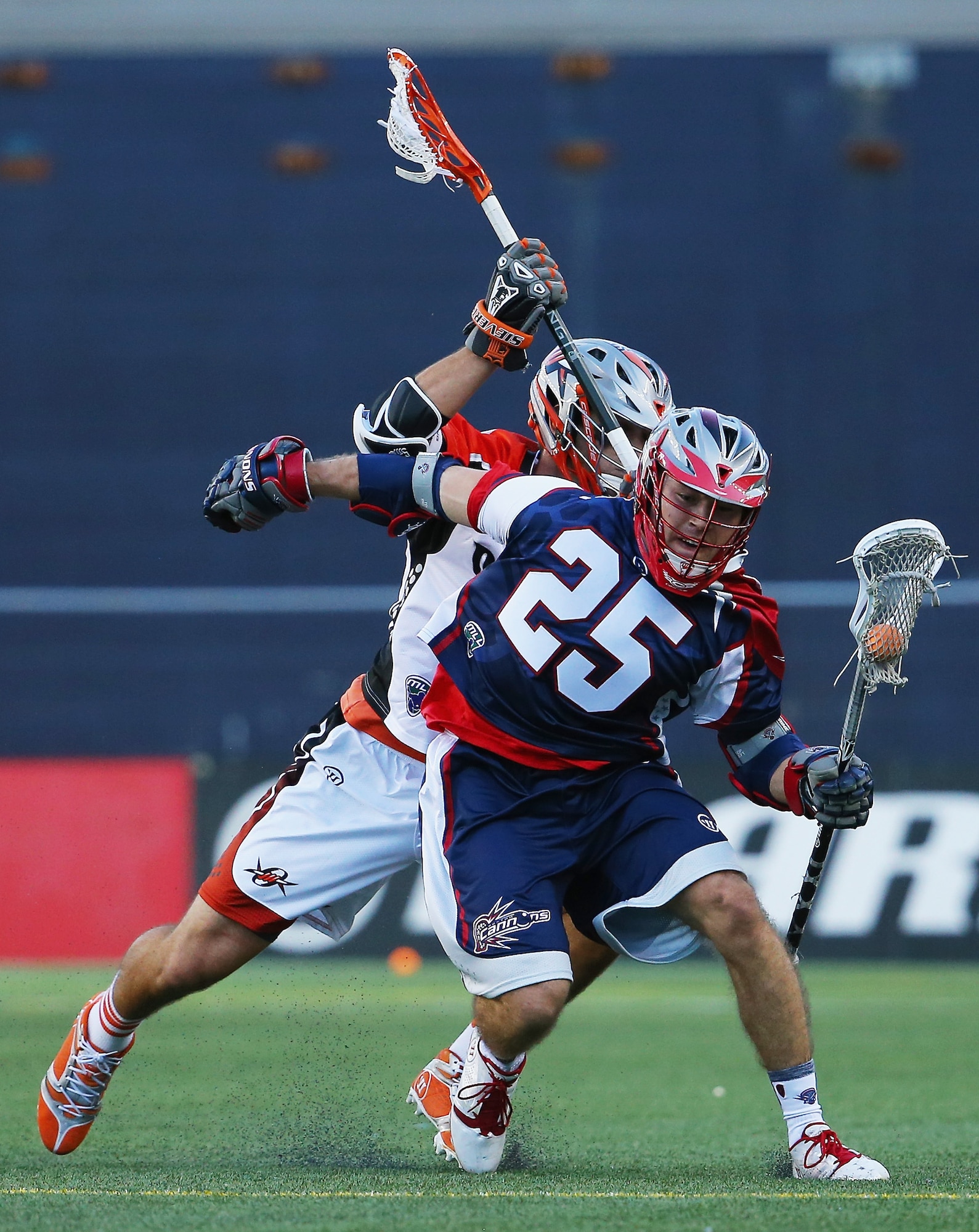 Erik Smith (25) battles a Denver Outlaws player during a Major League Lacrosse game at Gillette Stadium in Foxboro, Mass., April 12. Smith, who is a second lieutenant assigned to the C3I and Networks Directorate at Hanscom Air Force Base, was drafted last year by the Boston Cannons professional lacrosse team in the MLL draft. (Courtesy photo)