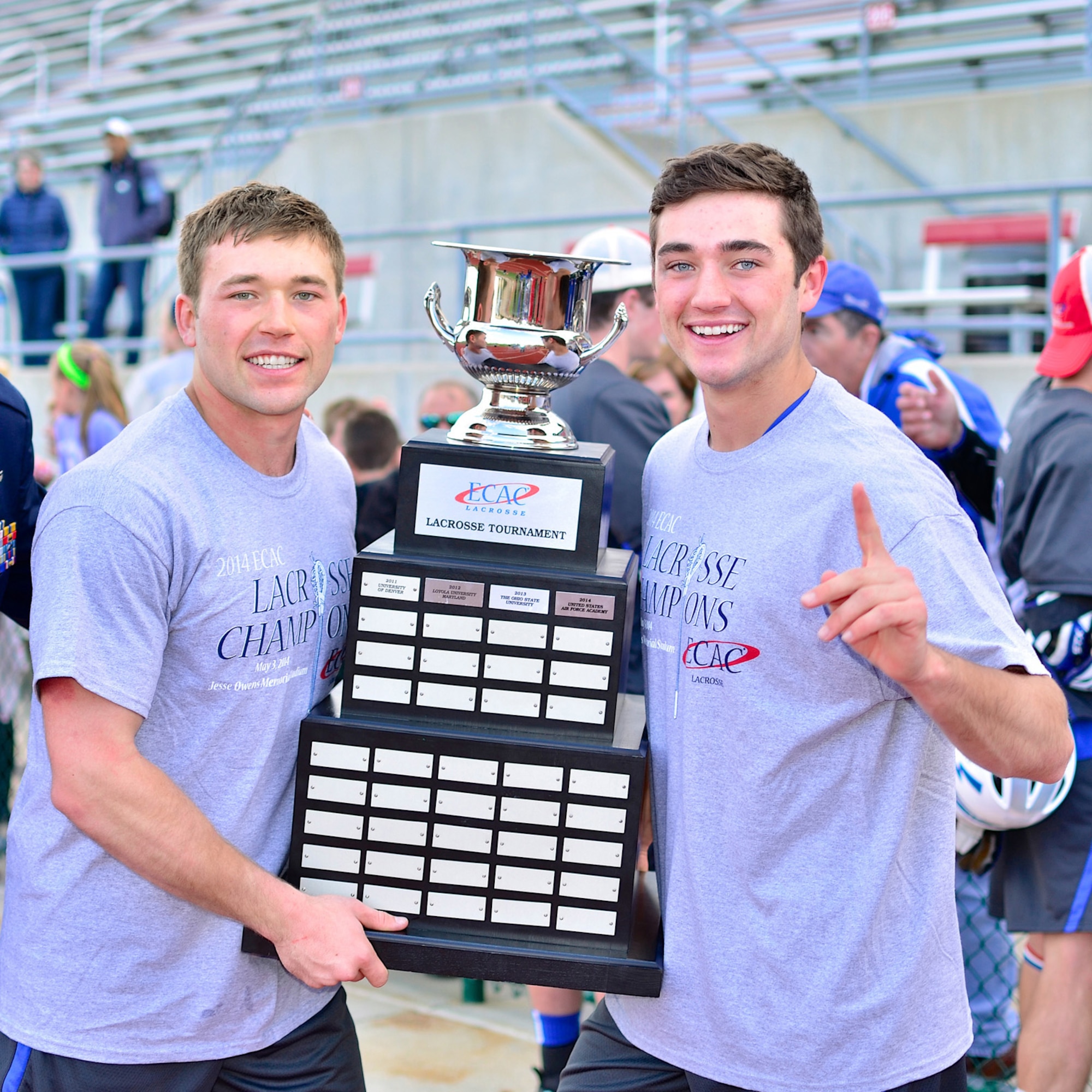 U.S. Air Force Academy Falcons Cadets Eric (right) and Austin Smith pose for a photo with the Eastern College Athletic Conference trophy after beating Fairfield University 9 to 8 in the conference championship game May 3, 2014. Second Lt. Erik Smith, C3I and Networks Directorate program manager at Hanscom, was the first-ever academy lacrosse player drafted in the Major League Lacrosse draft. (Courtesy photo)