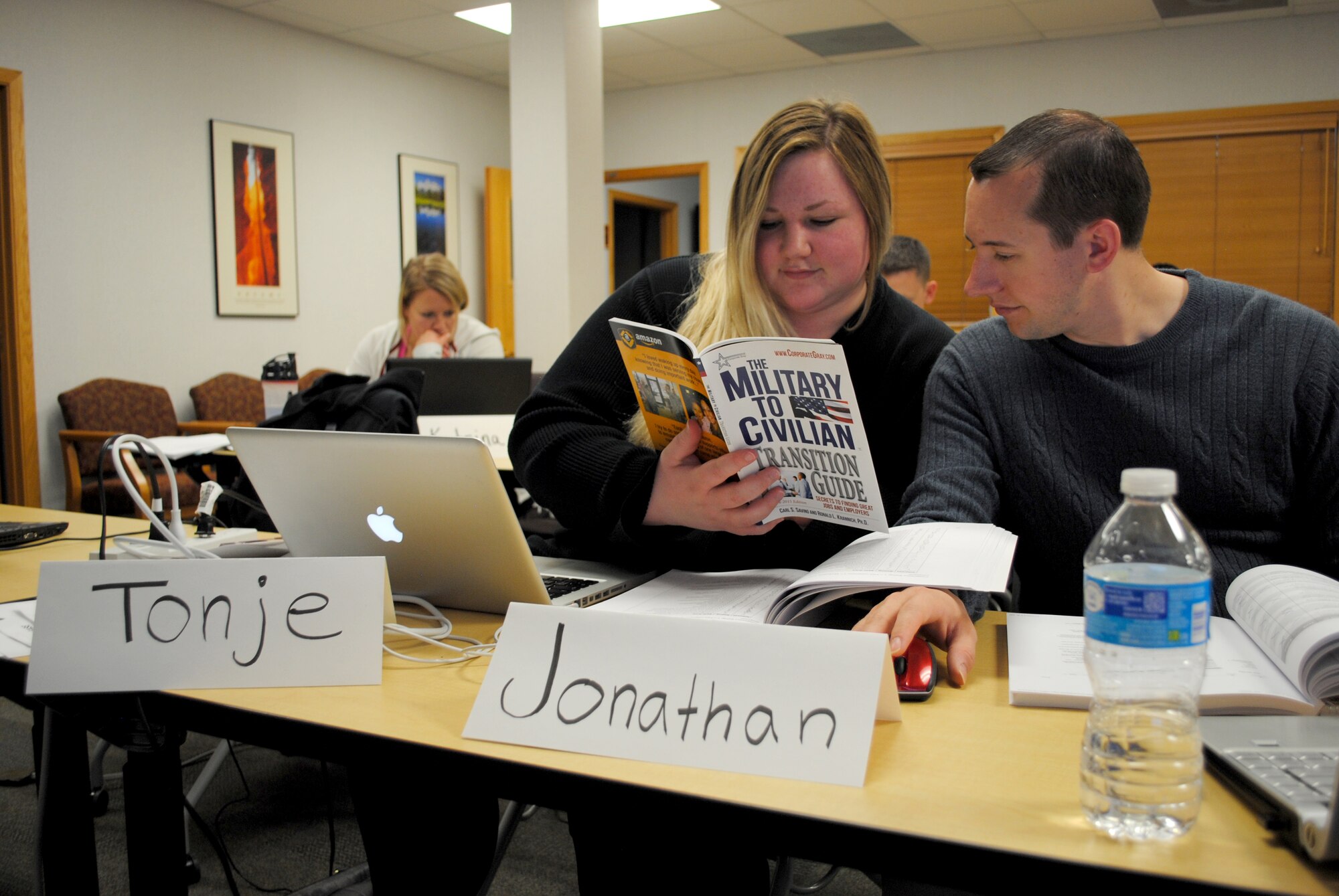 Senior Airman Jonathan Crossley from the 319th Civil Engineering Squadron and his fiancé Tonje Todal review a list of online research tools featured in the 2014-2015 edition of The Military to Civilian Transition Guide by Carl S. Savino and Ronald L. Krannich, Ph. D., May 13, 2015, at the Airman & Family Readiness Center on Grand Forks Air Force Base, N.D. Family members and significant others such as fiancés and civilian spouses are allowed to attend Transition Assistance Program seminars alongside the service member scheduled to separate or retire from military service. (U.S. Air Force photo by Staff Sgt. Luis Loza Gutierrez/released)