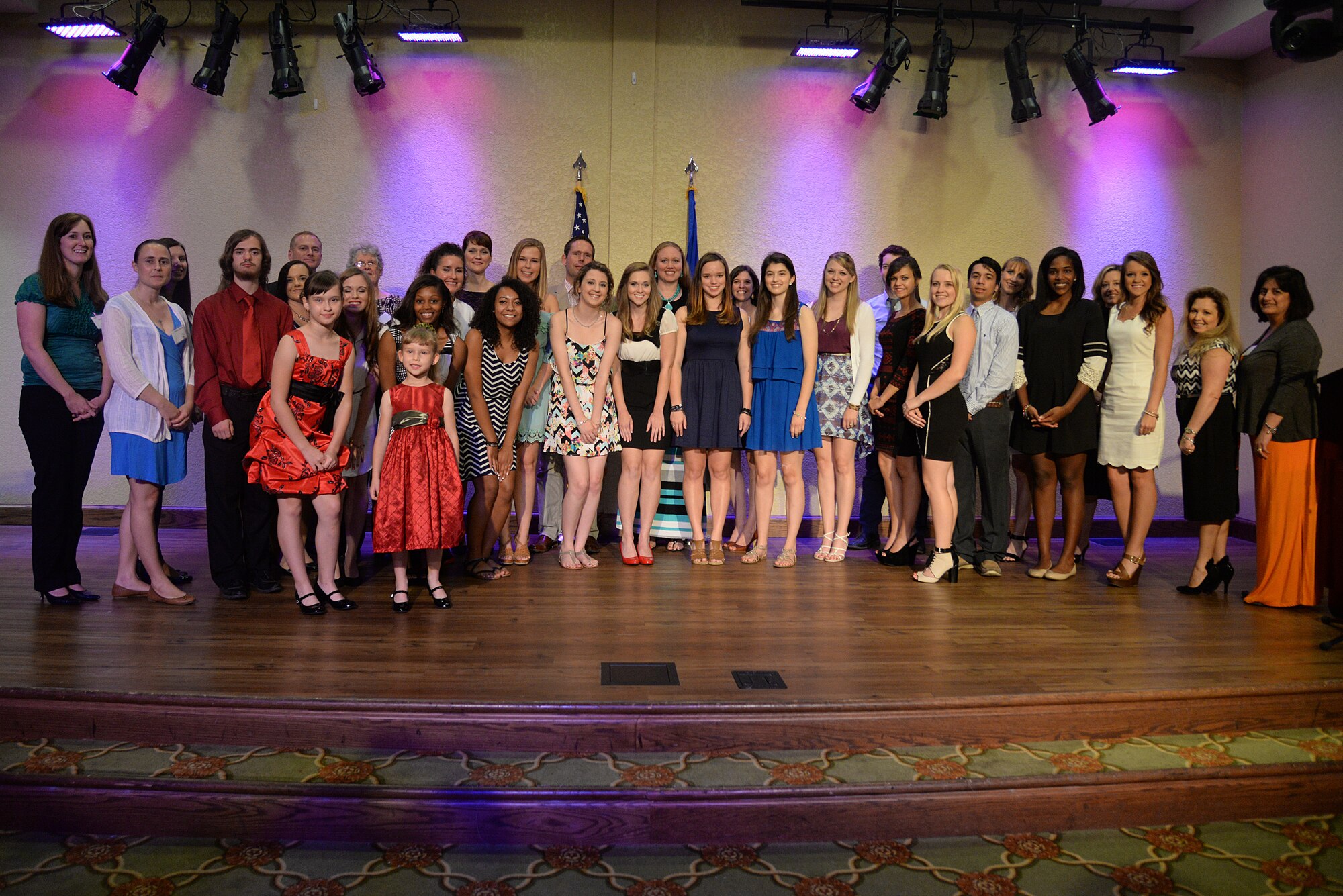 Keesler Spouses’ Club scholarship award recipients for 2015, club members and supporters pose for a photo at the 2015 Scholarship Award Banquet, May 12, 2015, Keesler Air Force Base, Miss . The KSC awarded a total of $23,000, with scholarships ranging from $1,000 to $2,000, to military dependents. (U.S. Air Force photo by Senior Airman Holly Mansfield)