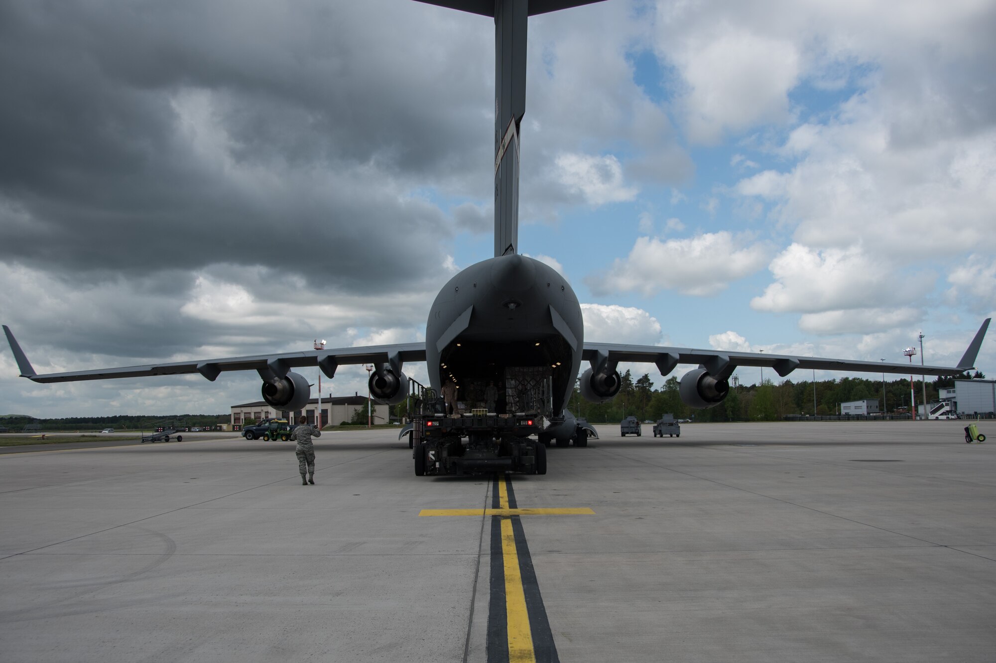 Airman 1st Class Katie Kelton, an air transportation specialist with the 32nd Aerial Port Squadron, spots the driver of a Tunner 60K loader as he backs away from a C-17 Globemaster III May 7, 2015, at Ramstein Air Base, Germany . The Tunner 60K loader suspension is hydraulically adjustable to facilitate driving the loader on or off the C-5 or C-17 for air transport. (U.S. Air Force photo by Staff Sgt. Jonathan Hehnly)