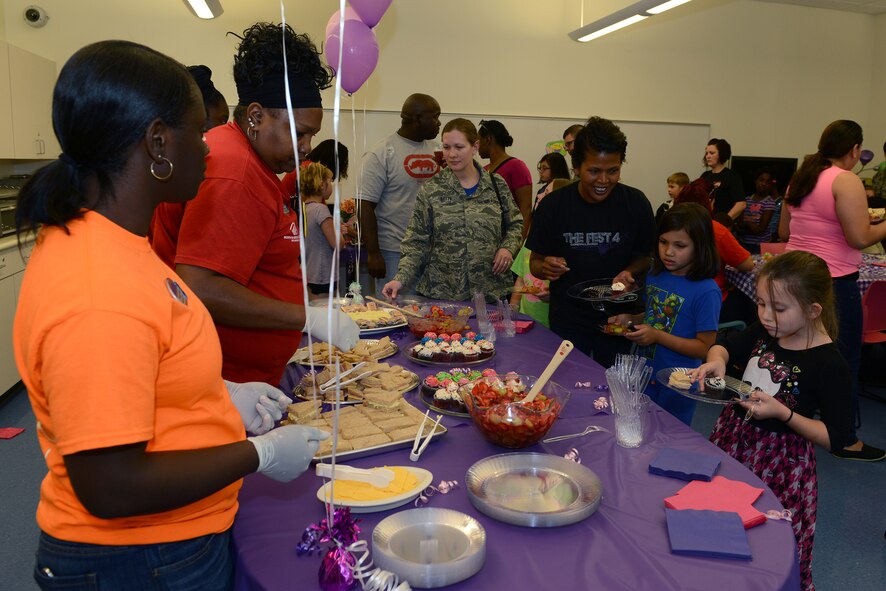 Youth Program employees serve tea, sandwiches, fruit salad and cupcakes to the families at the Youth Program Mother’s Day tea May 8, 2015, at Moody Air Force Base, Ga. The children showed appreciation for their mothers by giving gifts and making crafts for them during the event. (U.S. Air Force photo by Airman 1st Class Kathleen D. Bryant)