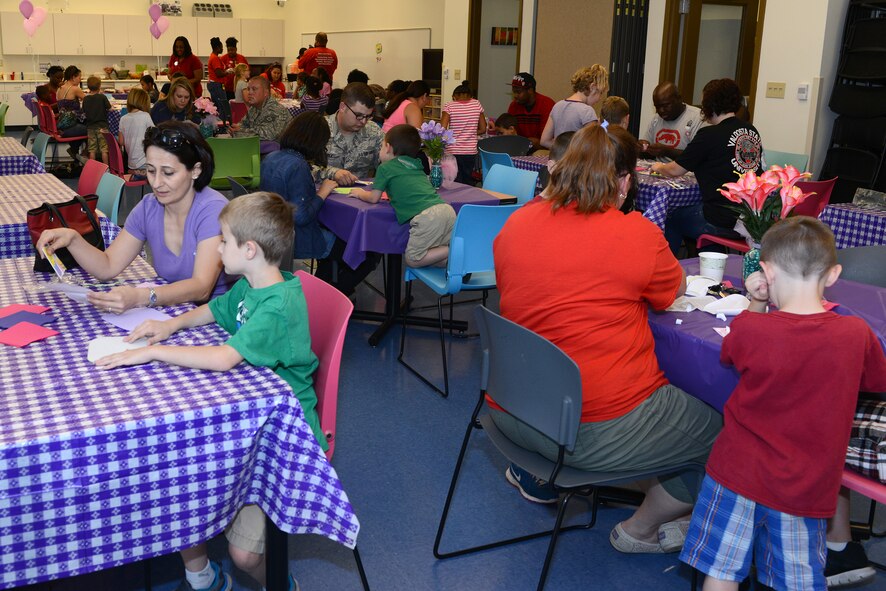 Families make crafts during the Youth Program Mother’s Day tea May 8, 2015, at Moody Air Force Base, Ga. Food and tea was served to the families after making the crafts. (U.S. Air Force photo by Airman 1st Class Kathleen D. Bryant)