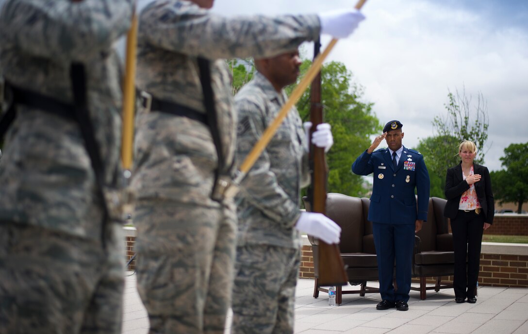 Col. Victor Moncrieffe II, 11th Security Forces Group commander, salutes while members of the 11th Security Forces Squadron honor guard team present the colors during a wreath laying ceremony for National Police Week on Joint Base Andrews, Md., May 11, 2015. The ceremony honored security forces and military police who have paid the ultimate sacrifice in the line of duty. (U.S. Air Force photo/Staff Sgt. Chad C. Strohmeyer) 
