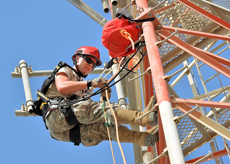 Senior Airman Eric, Cable Maintenance journeyman, , climbs a communication tower as part of a demonstration in support of the Air Force fall protection focus initiative at an undisclosed location in Southwest Asia May 11, 2015. According to the Air Force Safety Center website, the Air Force experiences hundreds of fall mishaps annually that result in thousands of lost man-hours as well as injuries and deaths. (U.S. Air Force photo/Tech. Sgt. Jeff Andrejcik) 