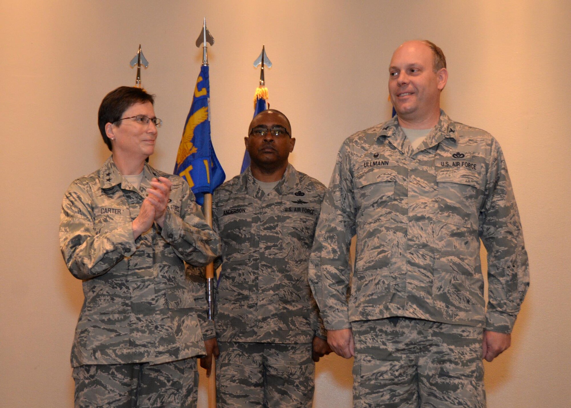 Maj. Gen. Theresa Carter, Air Force Installation and Mission Support Center commander, applauds after Col. Jeffrey Ullmann, Det. 10 commander, assumed command of the detachment during an activation ceremony at Barksdale AFB, La., May 13, 2015. Chief Master Sgt. Terence Anderson (center) will serve as the Det. 10 senior enlisted leader. The detachment is charged with serving as the consolidated installation and mission support function for Air Force Global Strike Command wings. (U.S. Air Force photo/Airman 1st Class Luke Hill)