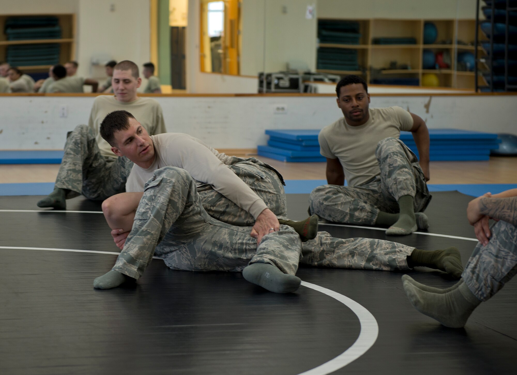 Tech. Sgt. Chance Farmer, 65th Security Forces Squadron noncommissioned officer in charge of training, demonstrates combatives moves during a class at the Chace Fitness Center on Lajes Field, Azores, Portugal, March 31, 2015. Farmer provided the combatives training to help hone members' close-quarters combat techniques and certify the students in security forces combatives. (U.S. Air Force photo/Staff Sgt. Zachary Wolf)