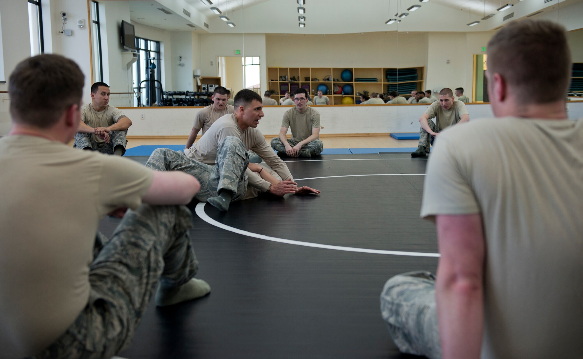 Tech. Sgt. Chance Farmer, 65th Security Forces Squadron noncommissioned officer in charge of training, demonstrates combatives moves during a class at the Chace Fitness Center on Lajes Field, Azores, Portugal, March 31, 2015. Farmer provided the combatives training to help hone members' close-quarters combat techniques and certify the students in security forces combatives. (U.S. Air Force photo/Staff Sgt. Zachary Wolf)