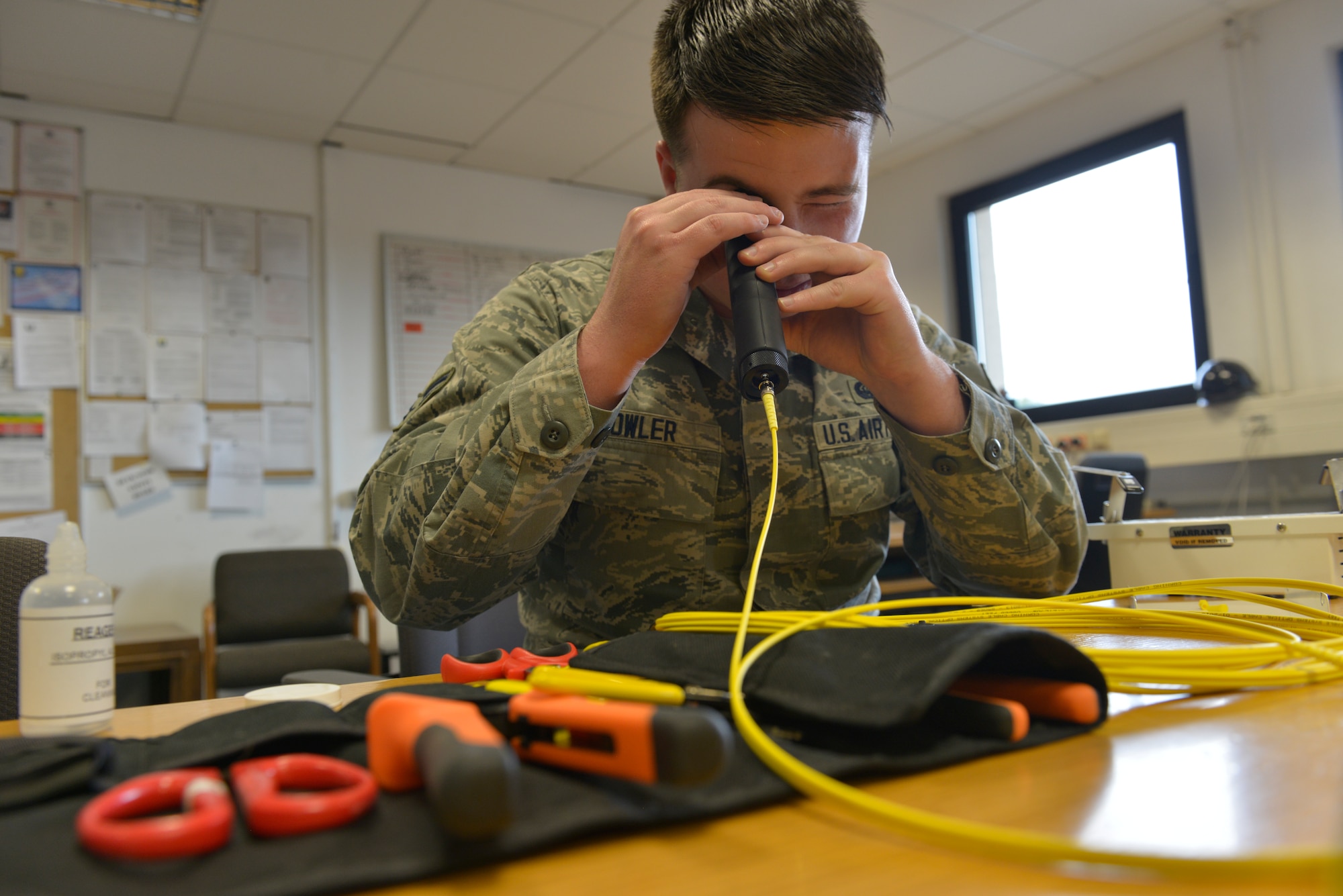 039 – Airman 1st Class Dillon Fowler, 86th Communications Squadron cable and maintenance technician, views the strand of fiber through a microscope April 30, 2015, at Ramstein Air Base, Germany.  Fowler was selected to attend the U.S. Air Force Academy’s preparatory school in via the Leaders Encouraging Airman Development program. After completing the preparatory school, he will enter the Academy as a cadet and potential officer. (U.S. Air Force photo by Airman 1st Class Lane T. Plummer/Released)