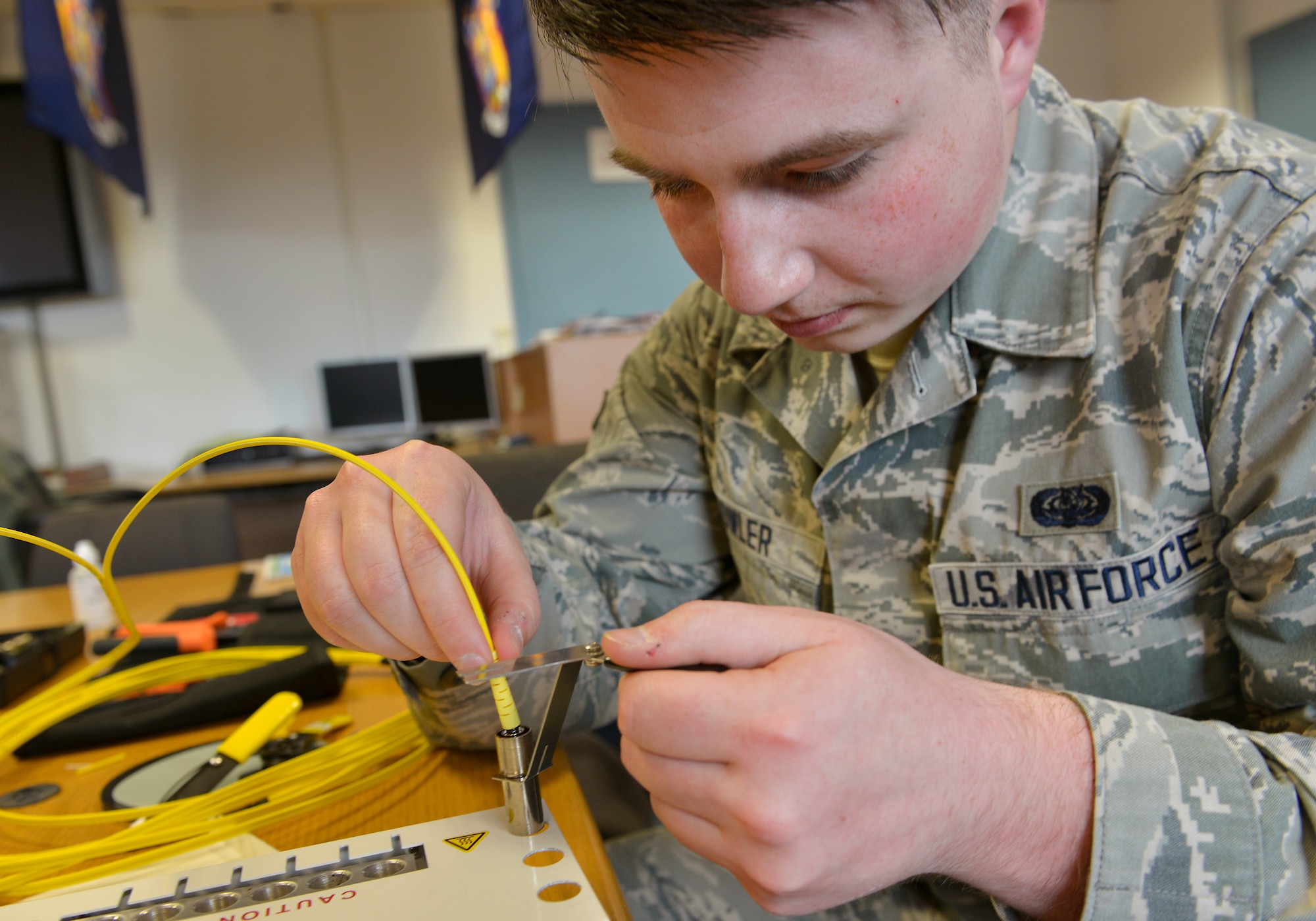 Airman 1st Class Dillon Fowler, 86th Communications Squadron cable and maintenance technician, slides fiber optics into an epoxy connector to create an end-to-end path April 30, 2015, at Ramstein Air Base, Germany.  Fowler was selected to attend the U.S. Air Force Academy’s preparatory school via the Leaders Encouraging Airman Development program. After completing the preparatory school, he will enter the Academy as a cadet and potential officer.(U.S. Air Force photo by Airman 1st Class Lane T. Plummer/Released)