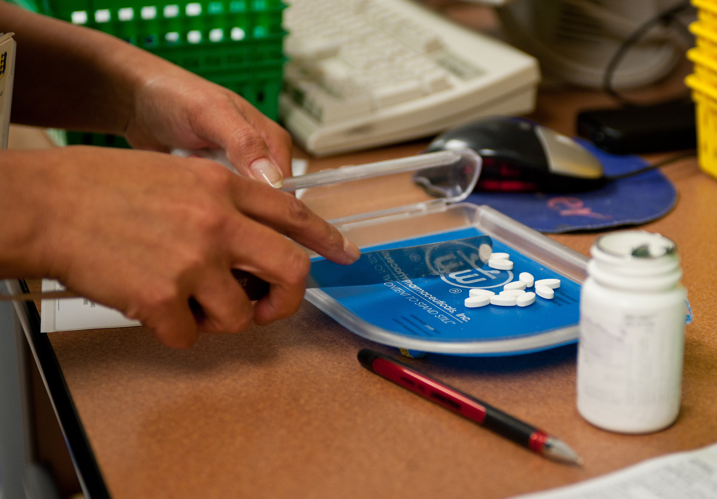 A pharmacy technician Counts Pills To Fill A Prescription At Ellsworth