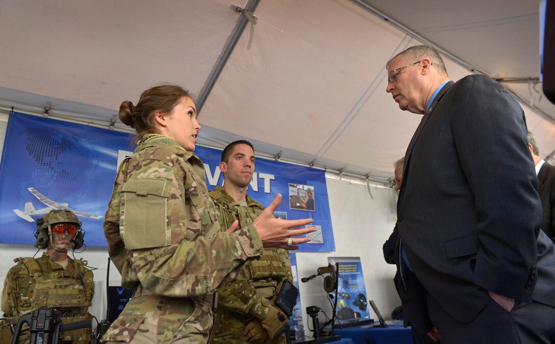 Air Force 1st Lt. Caroline Kurtz, a human factors engineer with the Air Force Research Laboratory, briefs Deputy Defense Secretary Bob Work on wearable technology systems as he tours exhibits during DoD Lab Day at the Pentagon, May 14, 2015. At center is behavioral scientist Air Force 2nd Lt. Anthony Eastin. DoD photo by Glenn Fawcett