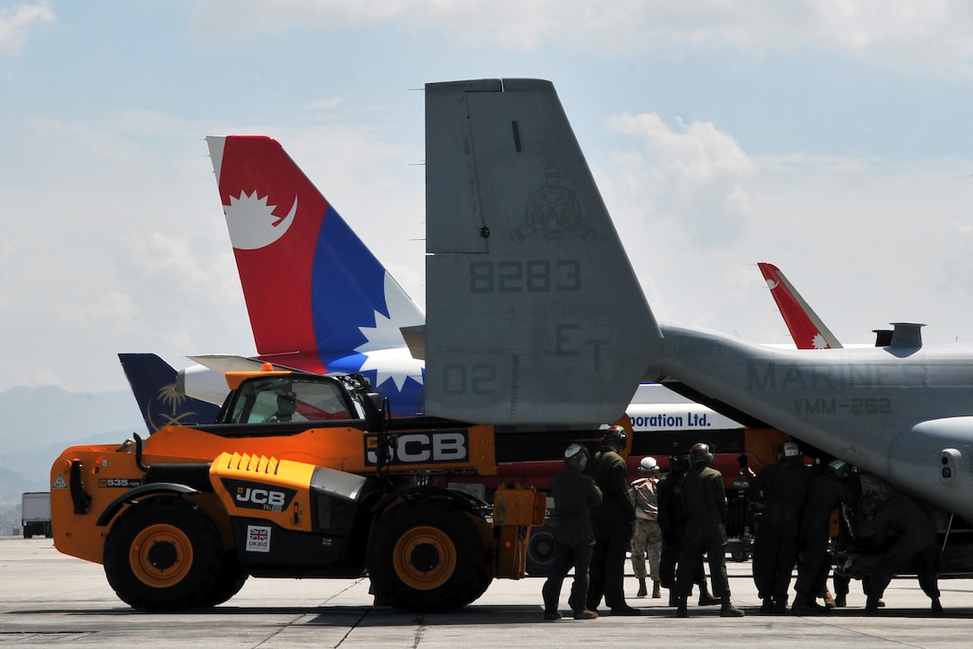 U.S. Air Force Staff Sgt. Josh Foley loads relief supplies onto a U.S. Marine Corps MV-22 Osprey tilt-rotor aircraft at Tribhuvan International Airport in Kathmandu, Nepal, May 14, 2015. The 36th Contingency Response Group airmen deployed to Nepal from Andersen Air Force Base, Guam, as part of Joint Task Force 505. The group responded to the government of Nepal and U.S. Agency for International Development by processing relief supplies and coordinating airfield operations after an earthquake devastated the country April 25, 2015. Foley is a aerial port supervisor assigned to the 36th Mobility Response Squadron.
