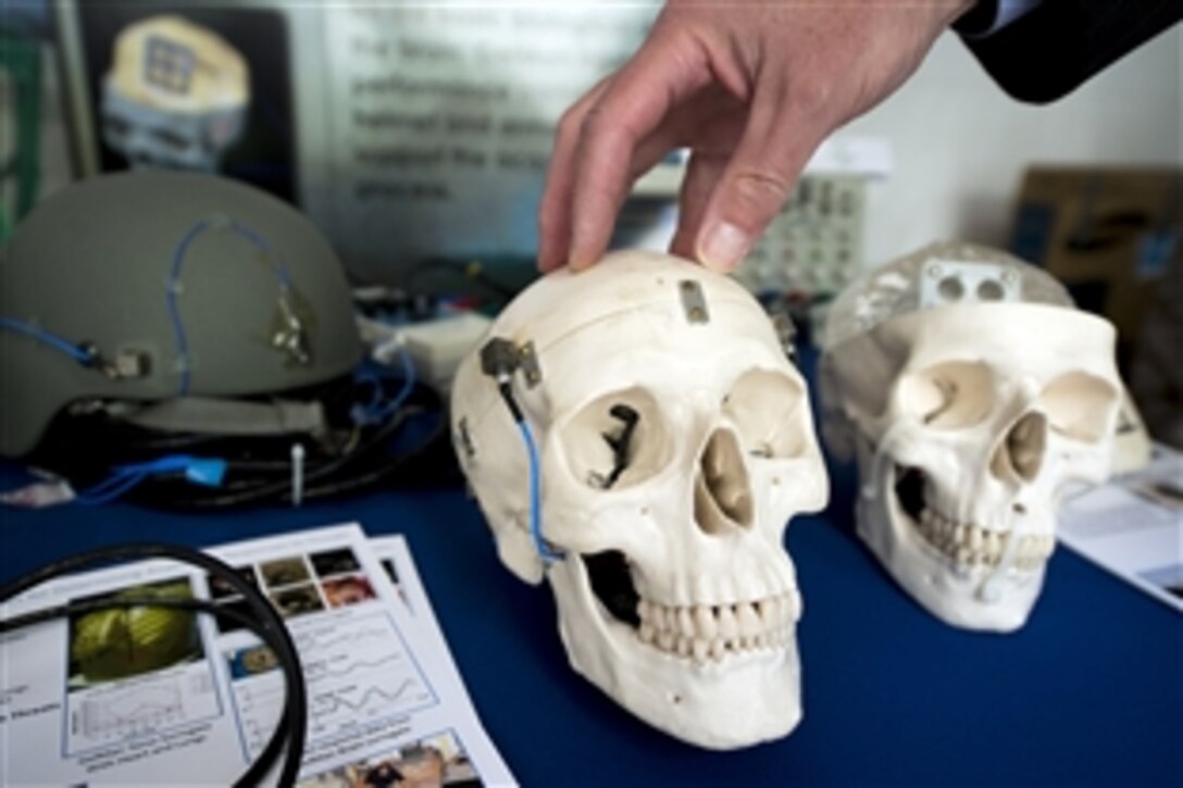 The hand of scientist Dr. Peter Matic rests on a skull as he explains how the Naval Research Laboratory is studying how to develop helmets for U.S. Marines that will improve protection from brain injuries. The demonstration was part of the preparation for the Defense Department's first Lab Day exhibition, May 14, 2015.