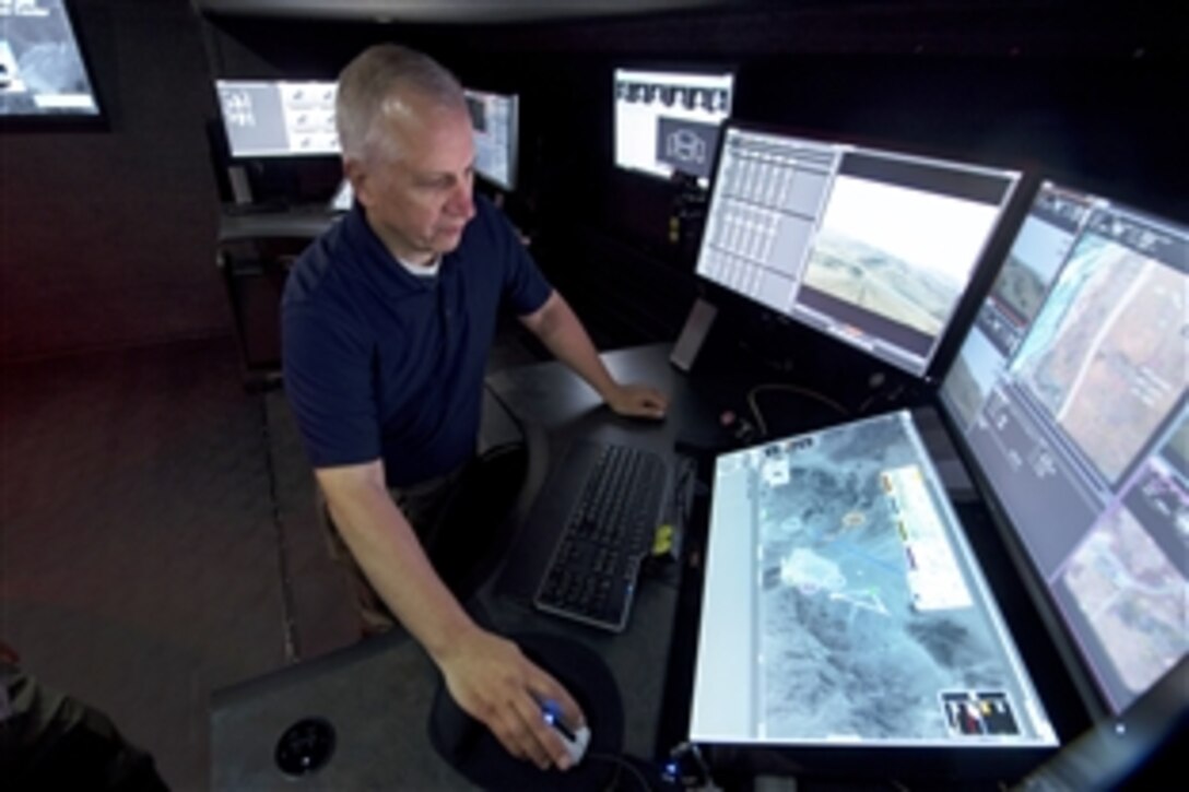 Gregory Feitshans demonstrates a system being developed allowing a single person to control multiple remote piloted aircraft. Feitshans is preparing the system for the Department of Defense Lab Day, May 14, 2015. Feitshans is a chief engineer at the Air Force Research Laboratory.