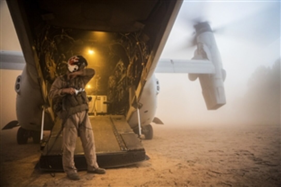 U.S. Marine Corps Staff Sgt. Matthew Shiver waits for earthquake victims to board an MV-22 Osprey at a landing zone near Charikot, Nepal, May 12, 2015. Shiver is an Osprey crew chief with Joint Task Force 505. 
