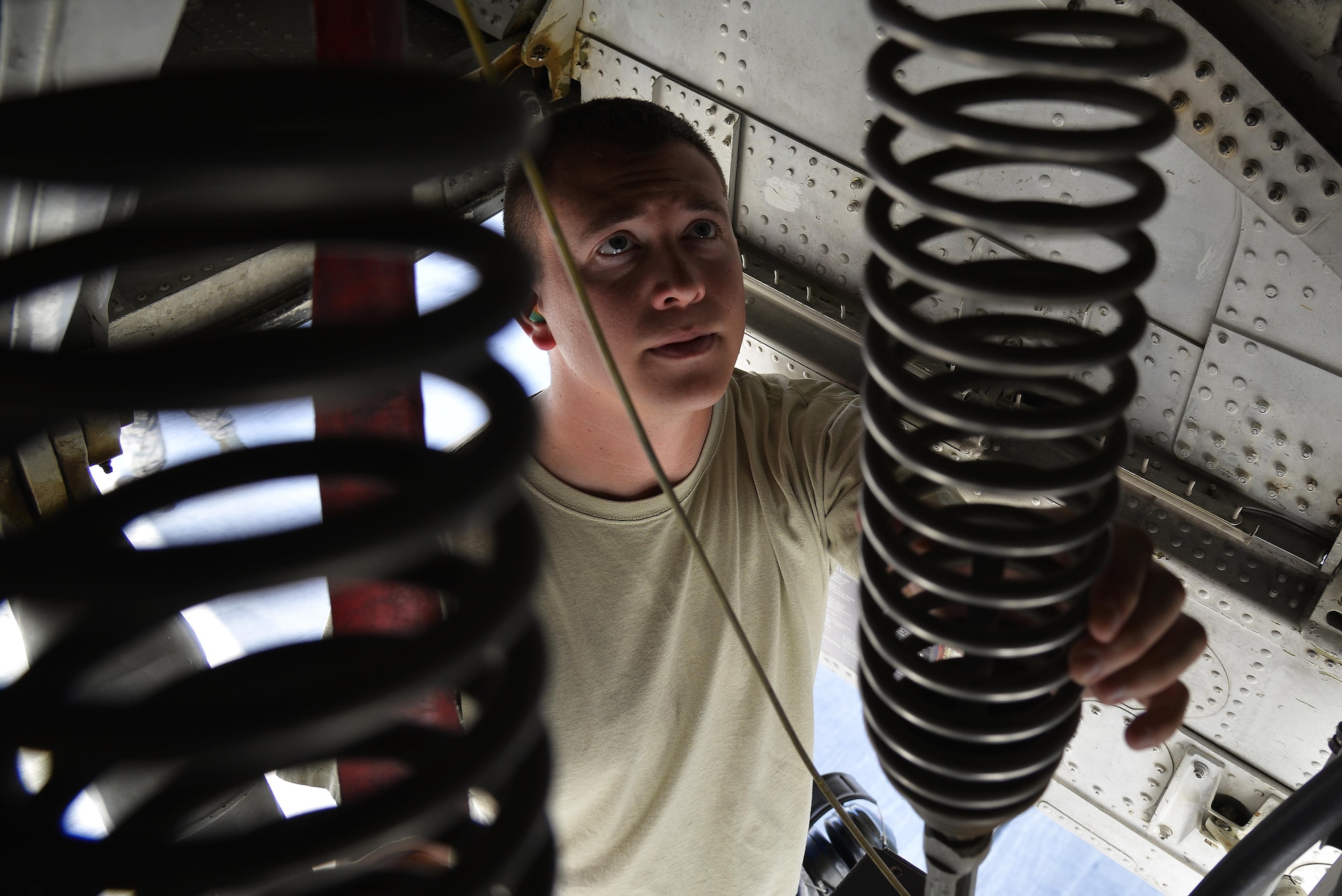 Staff Sgt. Michael inspects the retract system on the nose strut of a KC-10 Extender at an undisclosed location in Southwest Asia May 12, 2015. The retract system lowers and raises the landing gear. Michael is a crew chief assigned to the Expeditionary Aircraft Maintenance Squadron. (U.S. Air Force photo/Tech. Sgt. Christopher Boitz)