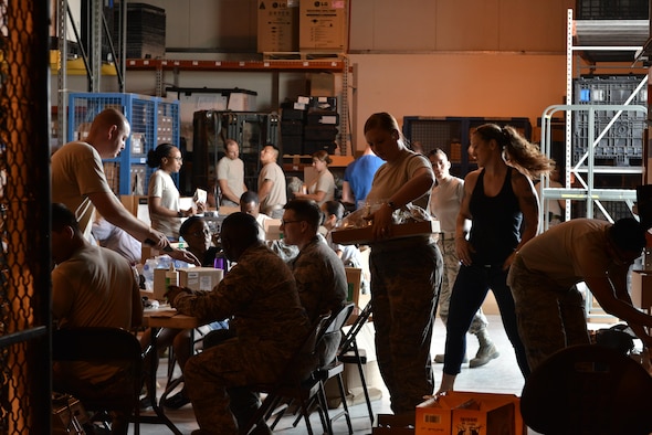 Service members deployed to Al Udeid Air Base sort Individual First-Aid Kits (IFAK) supplies for recertification May 8, 2015 at Al Udeid Air Base, Qatar. Medical Logistics airmen began an IFAK packing volunteer event that has last lasted several months. Each month, more volunteers help meet an 18,000 unit quota to help service members downrange. (U.S. Air Force photo by Staff Sgt. Alexandre Montes)  