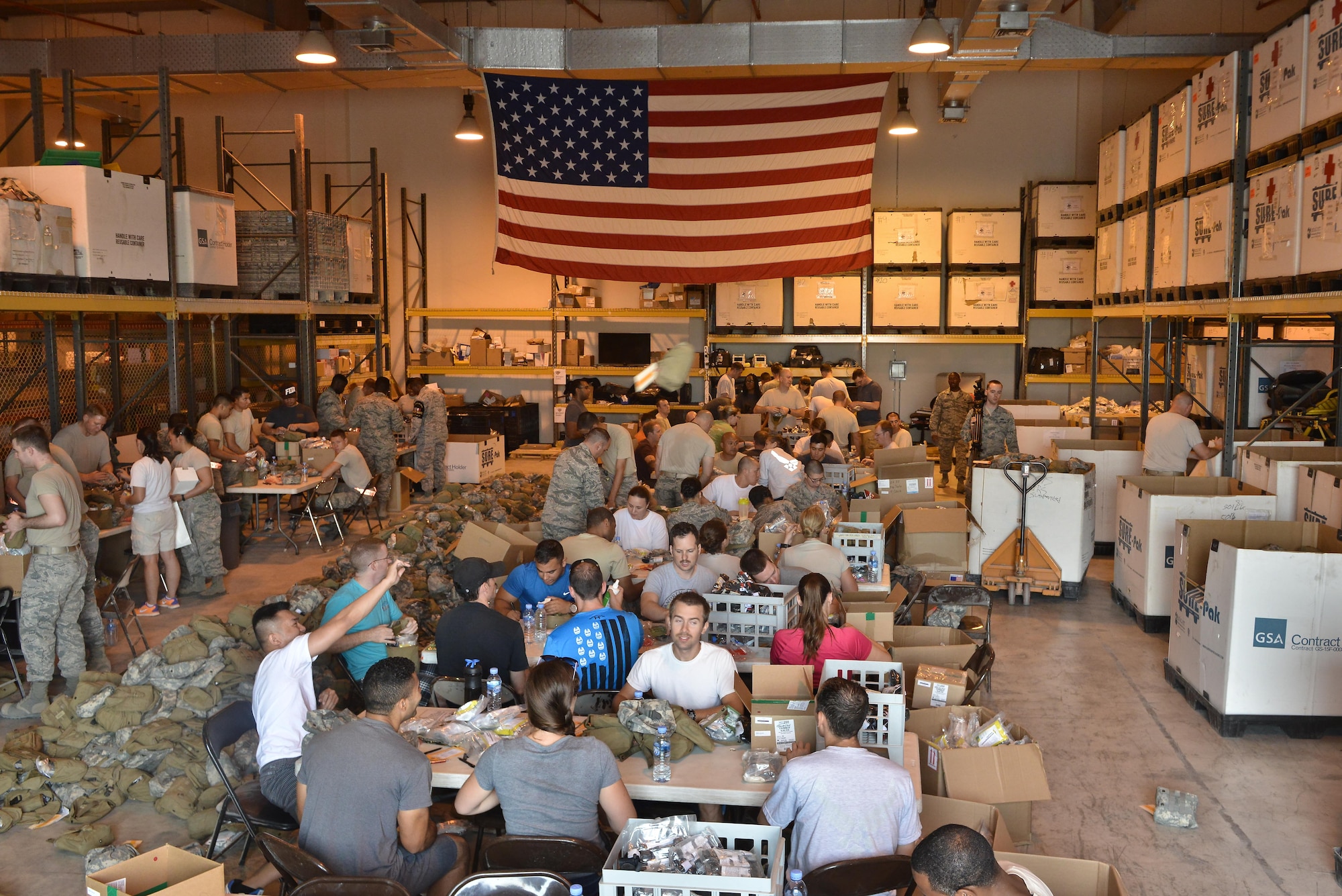 Over 100 airmen came out to show their support and help unpack and pack serviceable Improved First-Aid Kits (IFAK) during a volunteer event May 8, 2015 at Al Udeid Air Base, Qatar.  379th Medical Logistics Squadron airmen began an IFAK packing volunteer event that has last lasted several months. Each month, more volunteers help meet an 18,000 unit quota to help service members downrange. (U.S. Air Force photo by Staff Sgt. Alexandre Montes)  