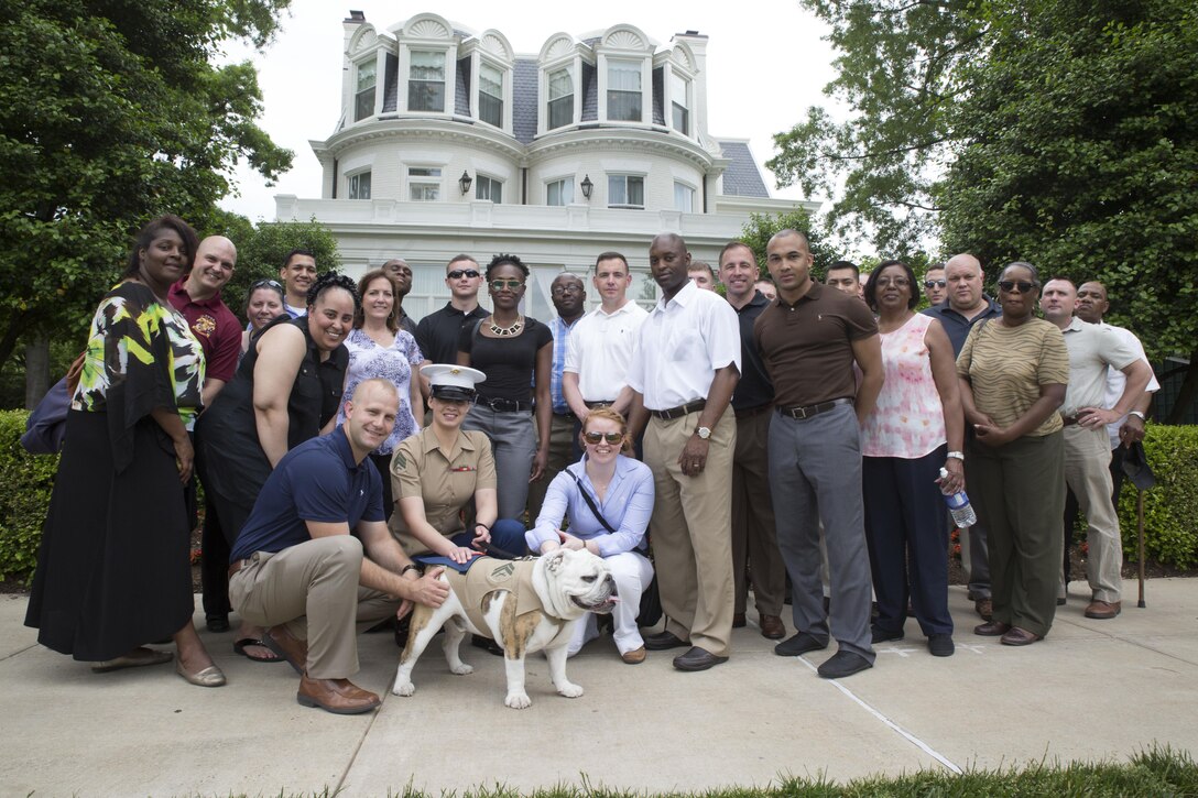 Marines from Marine Corps Recruiting Command pose in front of the Commandants home during their visit to Marine Barracks Washington May 13. Marines took a tour of the facility and learned about the history behind the historic barracks.