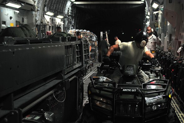 Senior Airman Louie Lacsina, a 36th Mobility Response Squadron air transportation specialist, unloads vehicles from a C-17 Globemaster III at Tribhuvan International Airport, Nepal, May 5, 2015. The 36th CRG is a rapid-deployment unit designed to establish and maintain airfield operations in a forward operating location. The unit joined the U.S. Department of State- and U.S. Agency for International Development-led humanitarian assistance and disaster relief operations in support of the government and armed forces of Nepal. (U.S. Air Force photo/Staff Sgt. Melissa White)